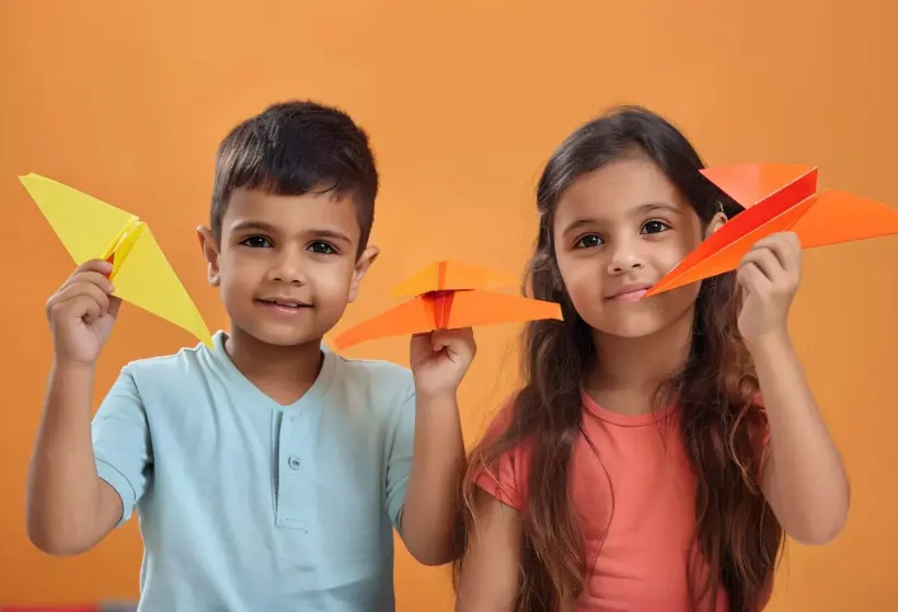 kids playing with paper plane