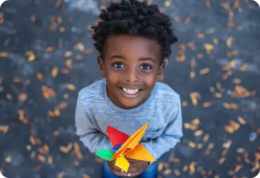 Boy holding a paper plane