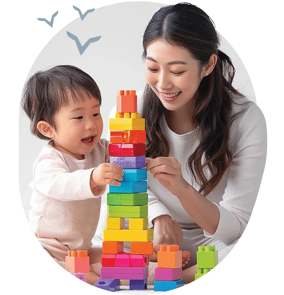 asian woman playing blocks with baby